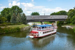 Welcome 33 The Bavarian Belle Riverboat on the River Cass in Frankenmuth Michigan, with the historic covered bridge in the background.