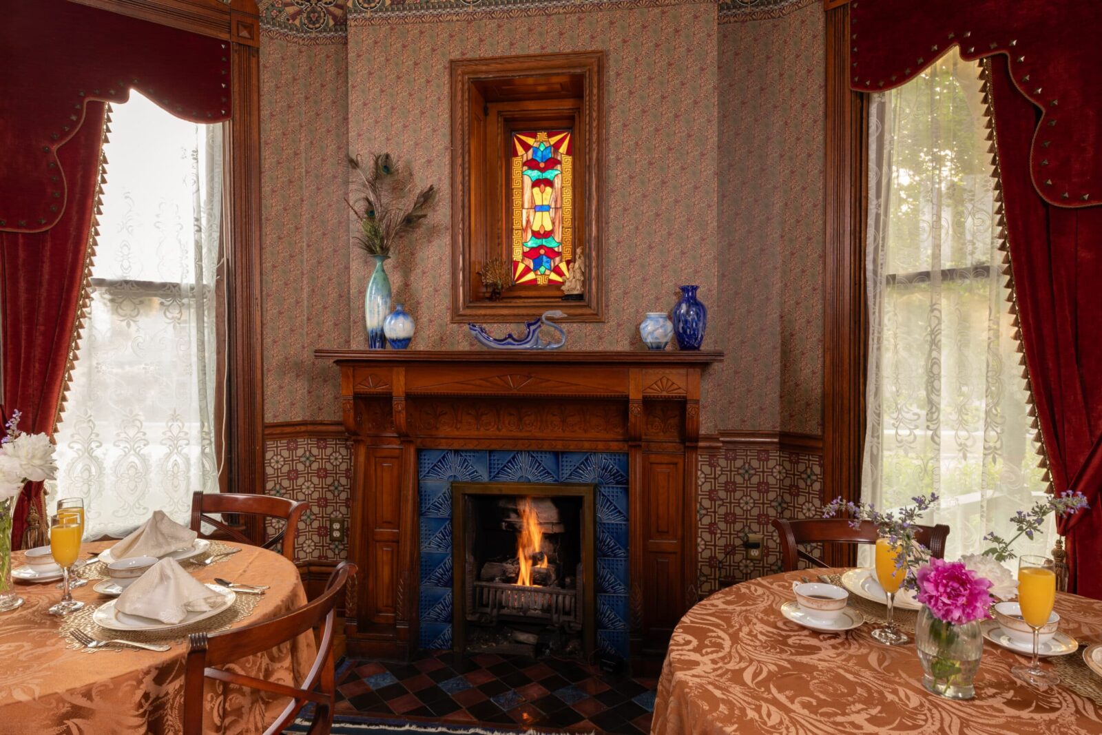 Tables set for breakfast by the fireplace in the common area of our Bed and Breakfast in Michigan